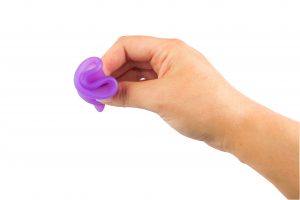 Studio shot of an isolated woman hand holding a menstrual cup